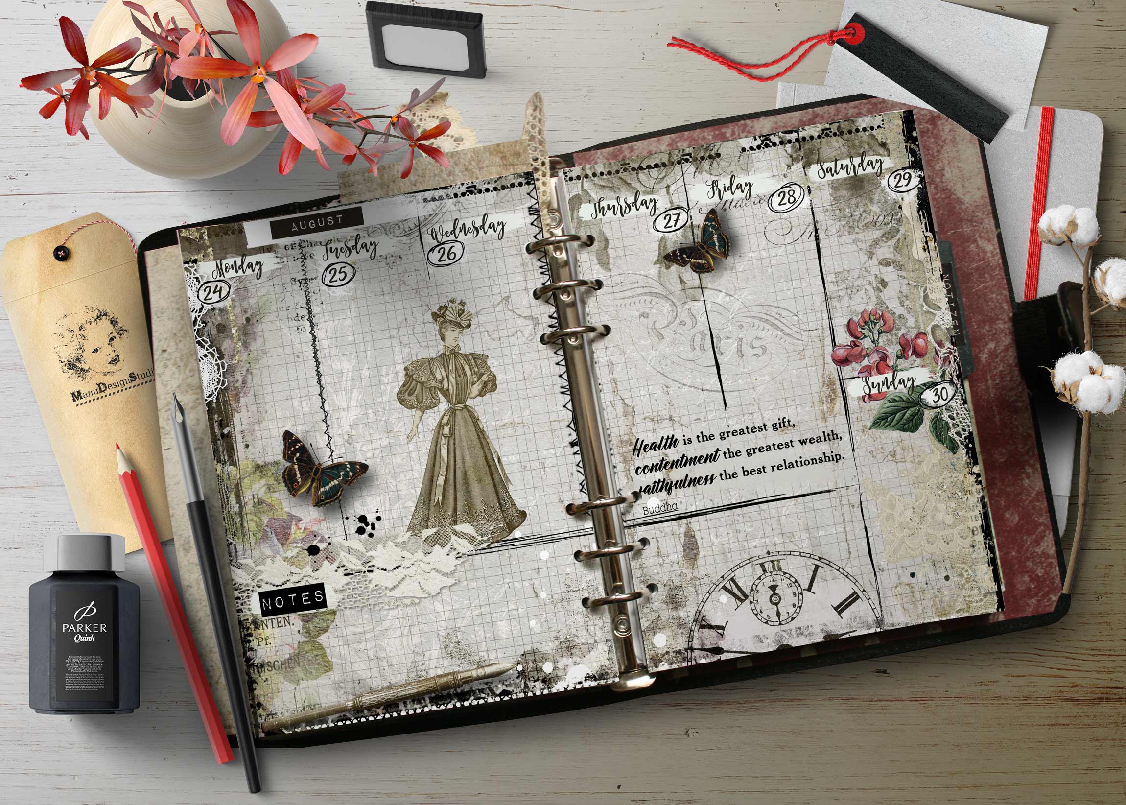 Open vintage ring-bound planner on a weathered desk, featuring butterfly illustrations, floral accents, and scattered stationery.