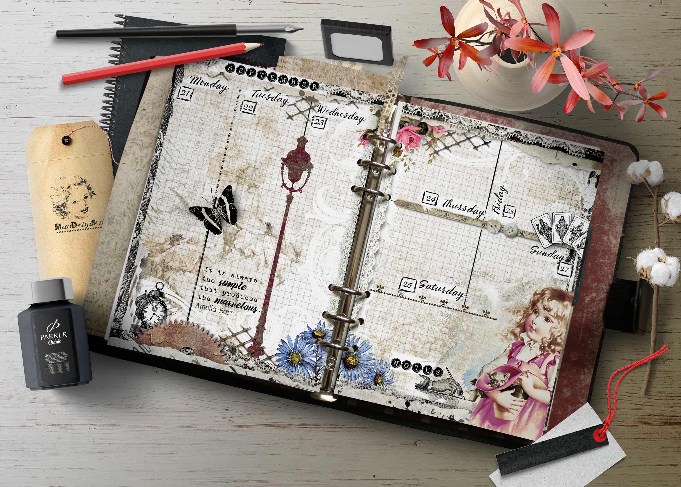 Vintage scrapbook planner open with calendar pages, pens, and pink flowers on a wooden table surface.