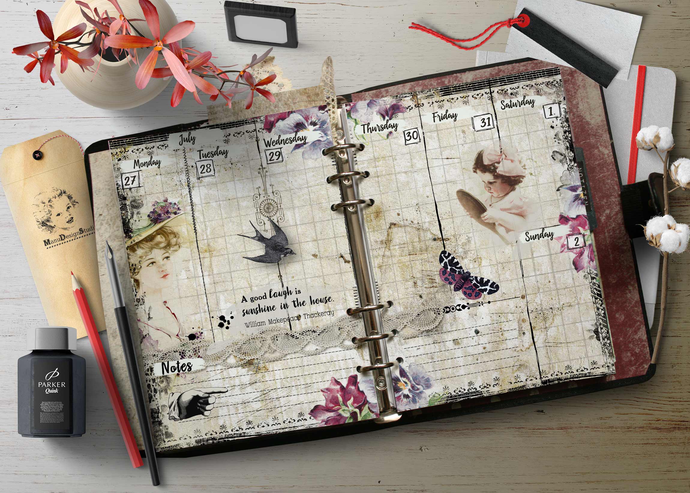 Open decorative planner with vintage pages, flowers, and butterfly illustrations on a white wooden desk, with pens and ink nearby.