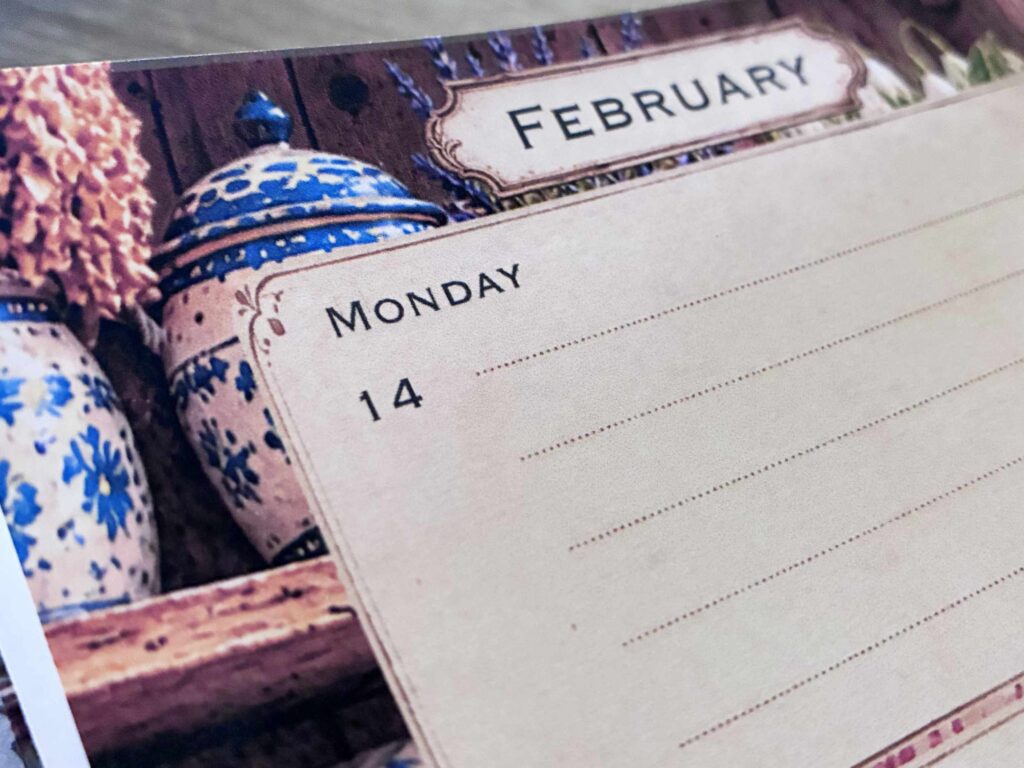 Close-up of a printable weekly planner page with blue floral pottery and lavender